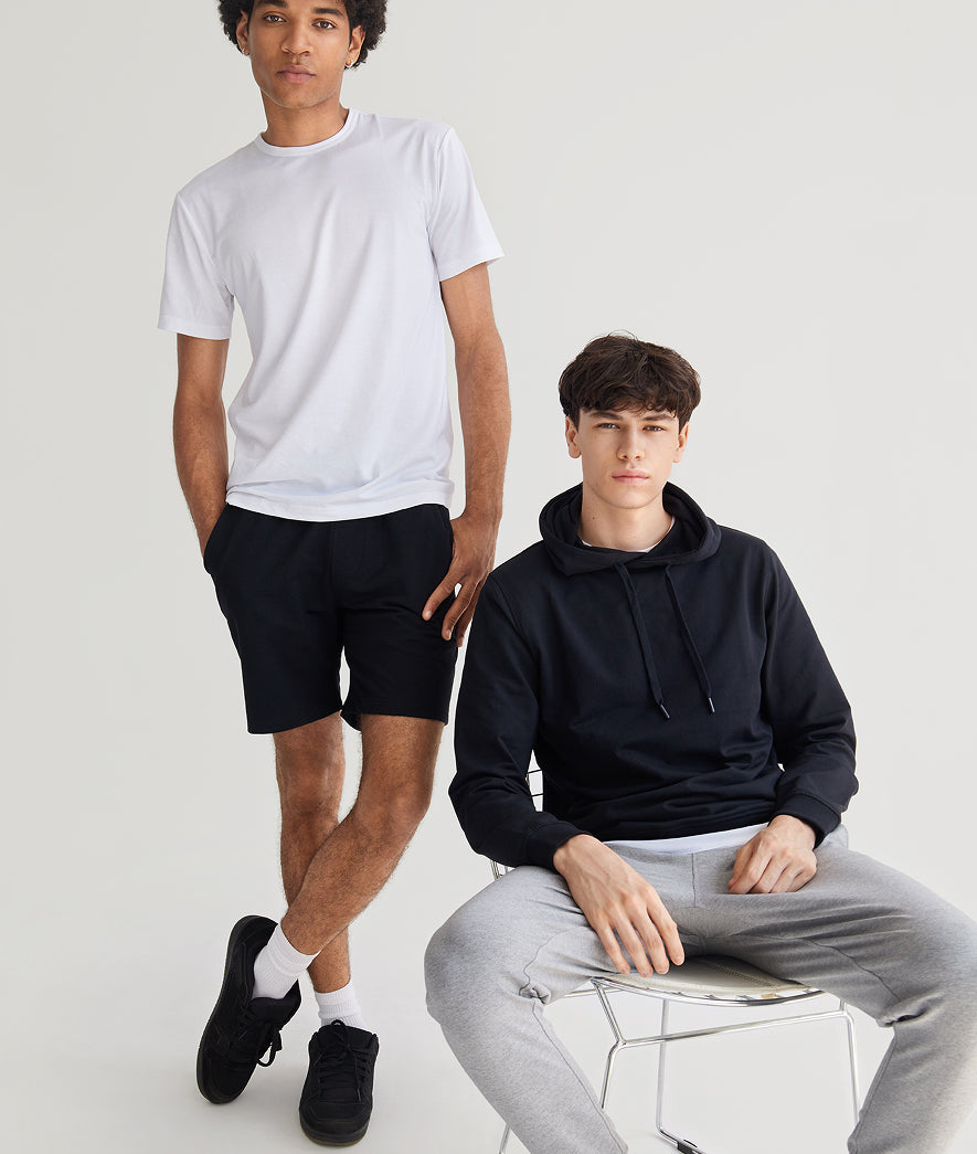 Two individuals wearing casual clothing on a plain background